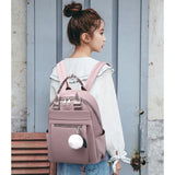 Women's Stylish Fashion Backpack - Waterproof Lightweight Casual Travel Bag - Adorable Plush Ball Detail - Available in Red, Blue, and Black Variants