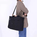 Stylish canvas shoulder bag for women, featuring multiple pockets, ideal for shopping, work, or daily use